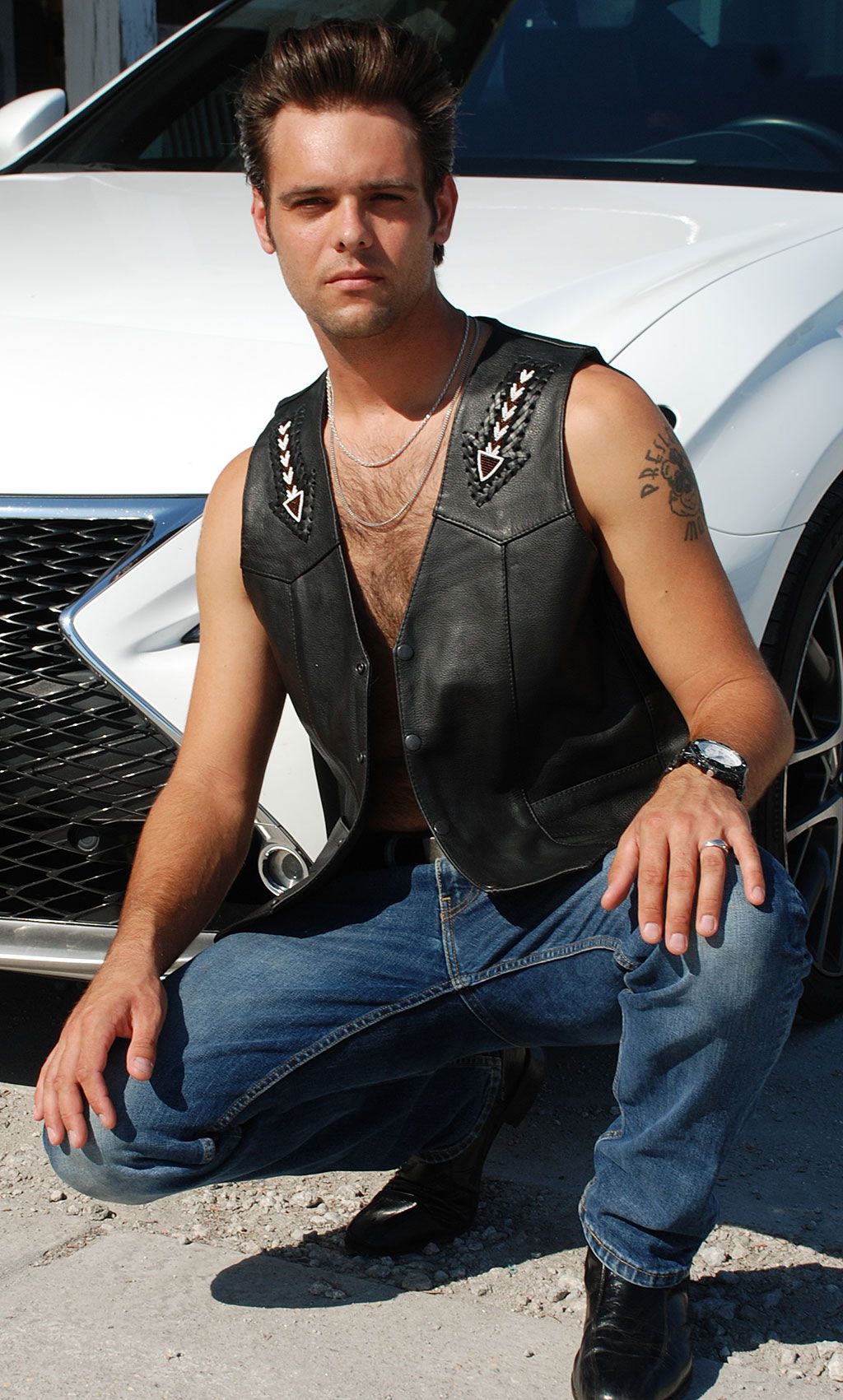 biker wearing a v-neck black leather biker vest 